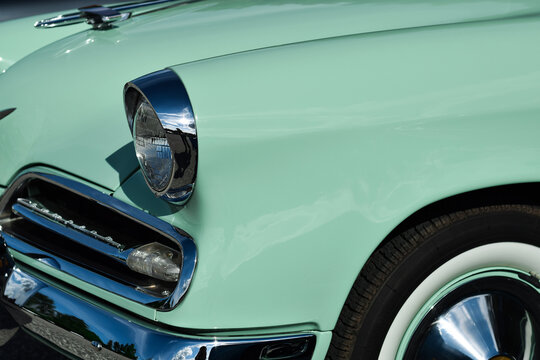 Closeup front headlight of the vintage retro mint green Studebaker Champion car