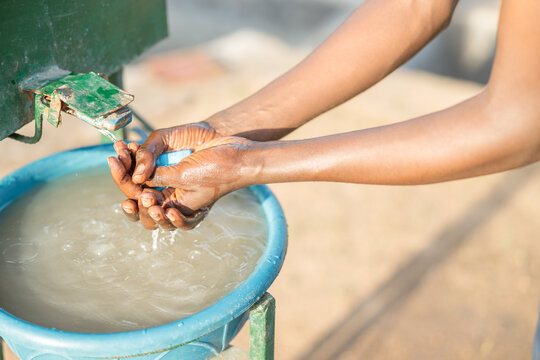 Cropped photo of African American worker washing hands at coffee farm in Africa region