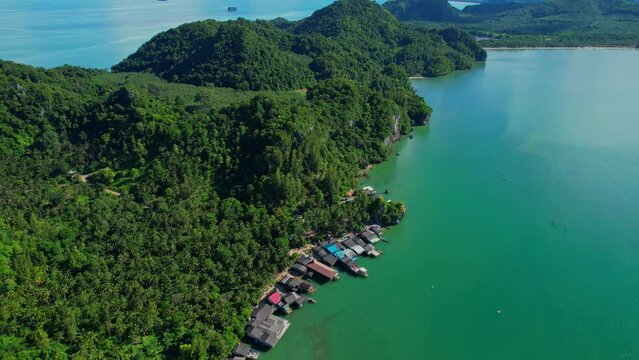 Drones are flying over Ao Kram in the beautiful tropical sea. Fisherman village and homestay, famous tourist attraction in Chumphon. Southern Thailand. travel vacation concept. 4k
