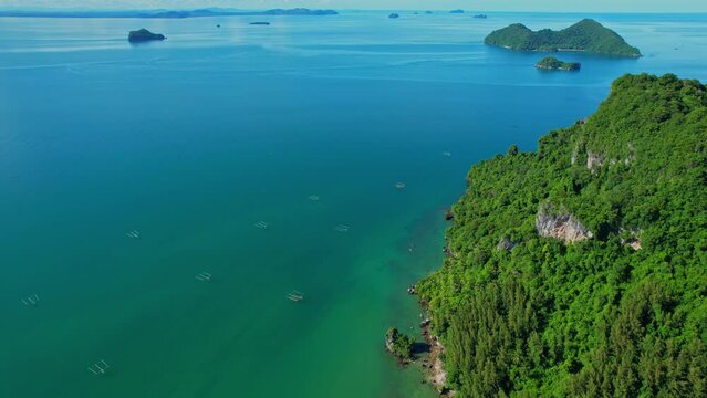 Drones are flying over the beautiful sea, many islands in the background, fish traps and squid traps on the sea, the fishing industry in Ao Kram, Chumphon, Southern Thailand. 4K drone footage
