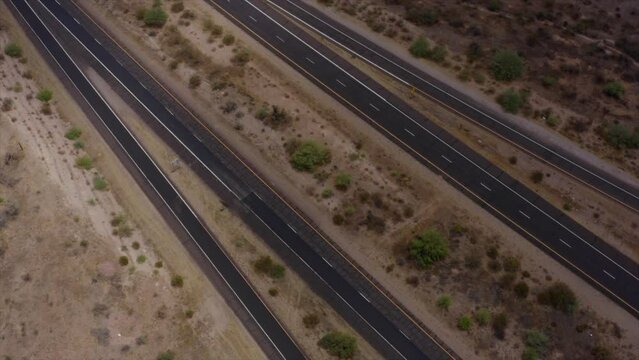 A cinematic aerial drone shot looking straight down over the Bush highway interchange along Arizona's Beeline highway (Highway 87).