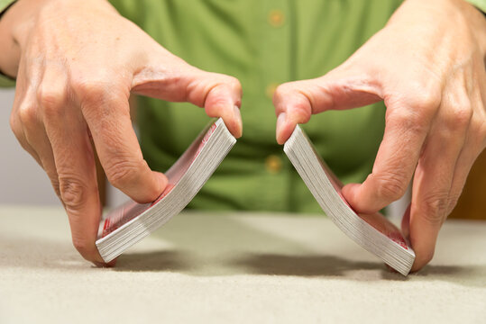 person shuffling cards for a card game