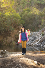 Naklejka premium teenage girls discovering forest and stream in autumn