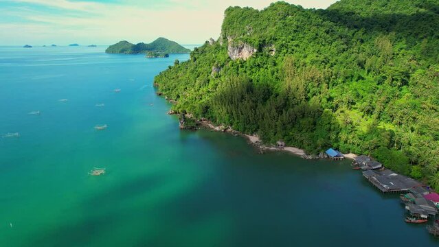 Drones are flying over Ao Kram in the beautiful tropical sea. Fisherman village and homestay, famous tourist attraction in Chumphon. Southern Thailand. travel vacation concept. 4k
