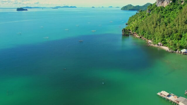 Drones are flying over the beautiful sea, many islands in the background, fish traps and squid traps on the sea, the fishing industry in Ao Kram, Chumphon, Southern Thailand. 4K drone footage
