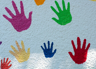 Multicolored handprints on white background. Top view