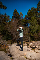 teenage girls discovering forest and stream in autumn