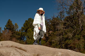 teen girl with straw hat and traditional argentinian gaucho poncho