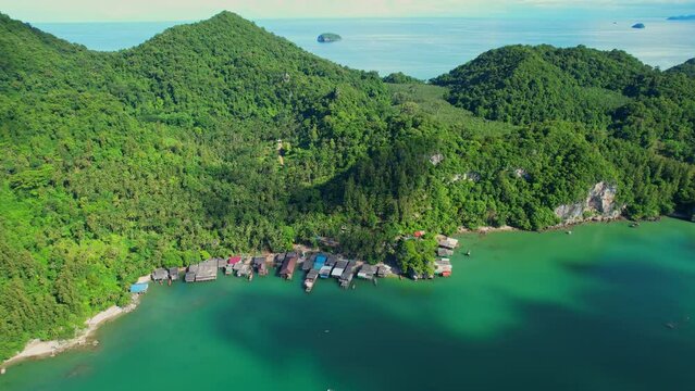 Fishing village at Ban Ao Kram. Ban Ao Kram has a homestay for tourists to stay and learn about the lifestyle of fishermen. Tropical sea at Chumphon, Thailand. Cinematic drone shot. 4k
