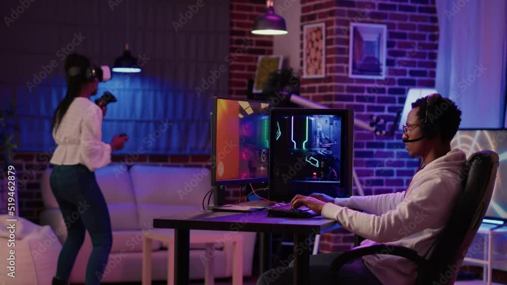 Poster gamer playing multiplayer first person shooter while gaming girl is fighting in virtual reality boxi