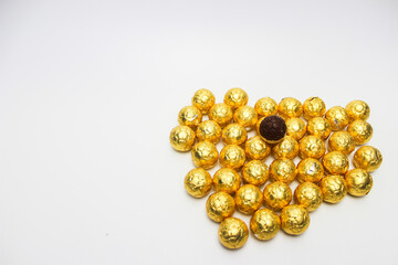 Soccer Ball-shaped chocolates in gold foil. Isolated