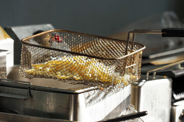 Fryer, frying potatoes. Deep fryer with french fries
