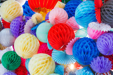 Multicolored paper pom-poms or honeycomb paper balls for the holiday decoration. Paper balls background - 519463495