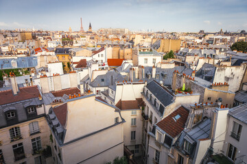 Eiffel tower and parisian roofs at golden sunrise Paris, France