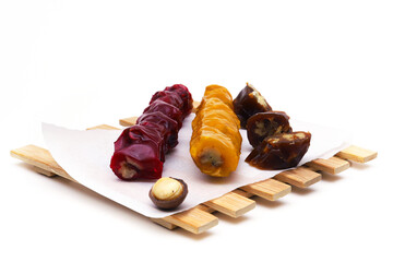 Pieces of churchkhela of different colors on a light background. Shallow depth of field