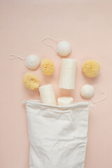 Zero waste Hygiene products.Natural cognac sponges and loofah washcloths and a beige cotton bag on...