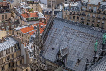 Notre Dame Cathedral of Paris spire from above with statues, France