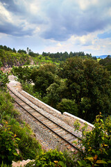 railway across of mountain with cloudy day and green vegetation around in the mogote state of mexico el oro 