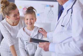 Little girl with her mother at a doctor on consultation