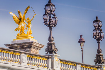 Fototapeta na wymiar Street lights and statues in Pont Alexandre III, Paris, france