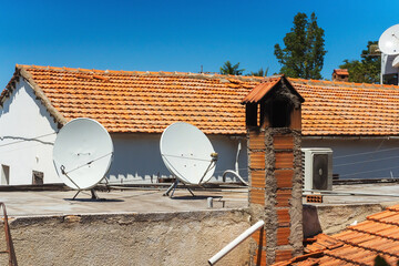 satellite dishes on the roof of a house in cyprus. wireless television in a private house. iron plates to receive the signal