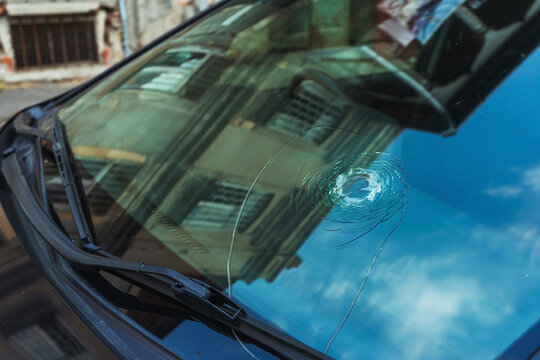 Large crack in the windshield of a car. Stone hitting the windshield of a car. Damaged glass protection of the driver of the transport