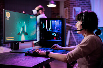 Modern gamer streaming online multiplayer video games play on computer, enjoying shooting gameplay...