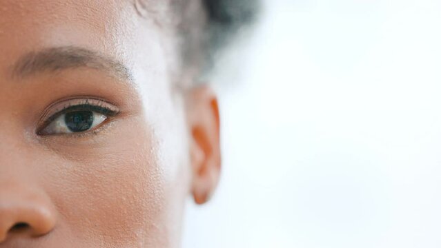 Closeup eye of african woman staring at the camera with copyspace for your text. Victim of gender based violence staying woke and aware. Closeup face of black woman with clear skin and makeup