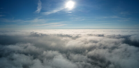 Fototapeta na wymiar Aerial view from high altitude of earth covered with puffy rainy clouds forming before rainstorm