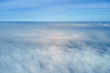 Aerial view from high altitude of earth covered with puffy rainy clouds forming before rainstorm
