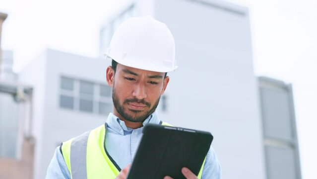 Thinking, content construction engineer typing on a tablet while onsite for inspection. Male architect or technician supervisor looking at operations while checking project plan using technology