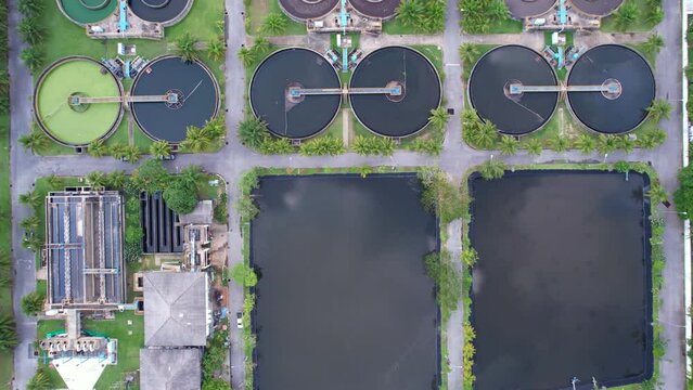 Aerial view High angle view Top down drone shot of the sewage treatment plant.The Solid contact clarifier tank type sludge recirculation in water treatment plant. Industrial wastewater treatment plant