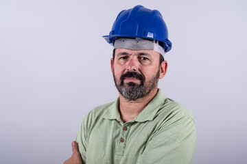 Portrait of happy mature architect in helmet standing male industrial inspector, 60s wearing shirt posing in studio.