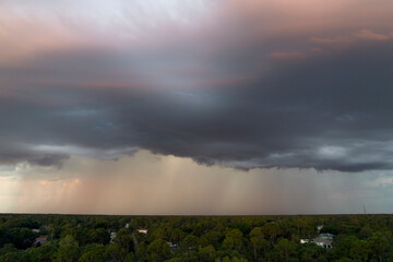 Landscape of dark ominous clouds forming on stormy sky before heavy thunderstorm over rural town...