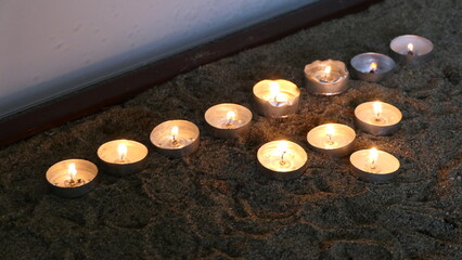 Shot of candle arrangement used in a religious Christian or catholic chapel 
