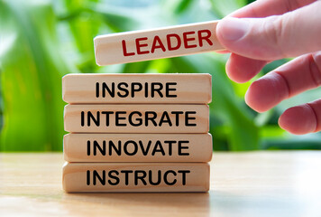 Hand holding wooden blocks with text - Leader, inspire, integrate, innovate, instruct.