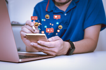 Man using smart phone with social media,with notification icons of like, message, email, comment and star above smartphone screen,social network 