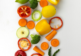 Healthy Mixed food in the center position on white background, Fresh Healthy vegetarian fruits and vegetables, broccoli, sweet bell chili cut, carrot, green peppers, and lemon