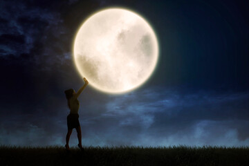 Fototapeta na wymiar Silhouette of businesswoman pushing a moon