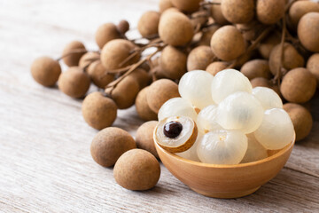 Fresh longan fruit on wooden table background. 