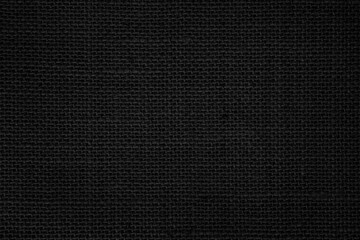 Black Hemp rope texture background. Haircloth wale black dark cloth wallpaper. Rustic sackcloth canvas fabric texture in natural.
