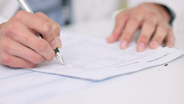 Closeup of the hands of a healthcare professional drafting a medical letter or form. A GP filing a document in an office. Doctor writing a prescription on paper on his desk at the hospital.