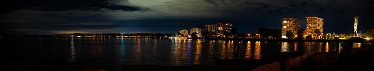 Downtown Barrie at night Centennial beach  night time panorama with lights reflecting on lake 
