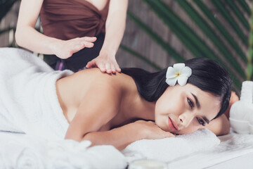 Obraz na płótnie Canvas Masseur doing massage on woman body in the spa salon, Asian woman on massage bed relax and lifestyle, massage hands treatment. Beauty treatment concept.