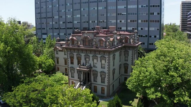 Wide reverse pullback aerial shot of the Stanford Mansion in Sacramento. 4K
