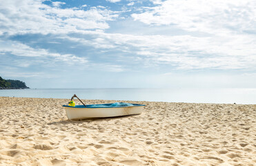 Fototapeta na wymiar Boat on sandy beach, tropical island in south of Thailand, fishing boat on the beach