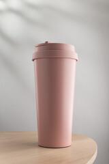 Pastel pink stainless steel tumbler size 20 ounce on wooden table