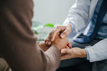 Hands of medical personnel comforting to reassure the patient in clinic.