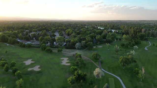 Aerial view of golf course along Front Range in northern Colorado at sunset. Drone footage filmed in Longmont, CO.