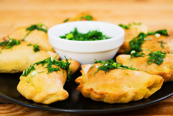 Baked dumplings with dill sauce. Close view